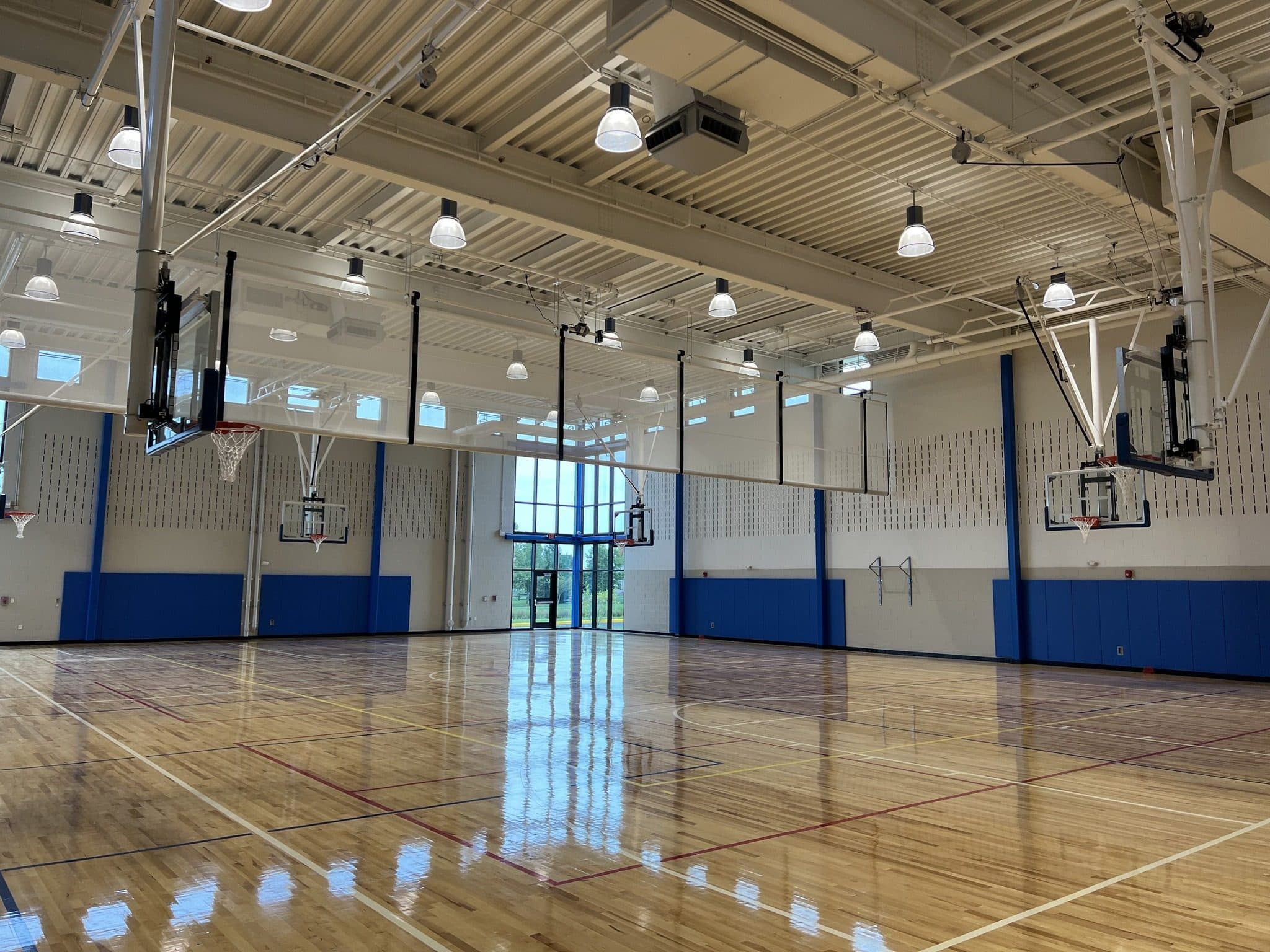 Gymnasium at the Middletown Family YMCA with high-bay lights over the courts