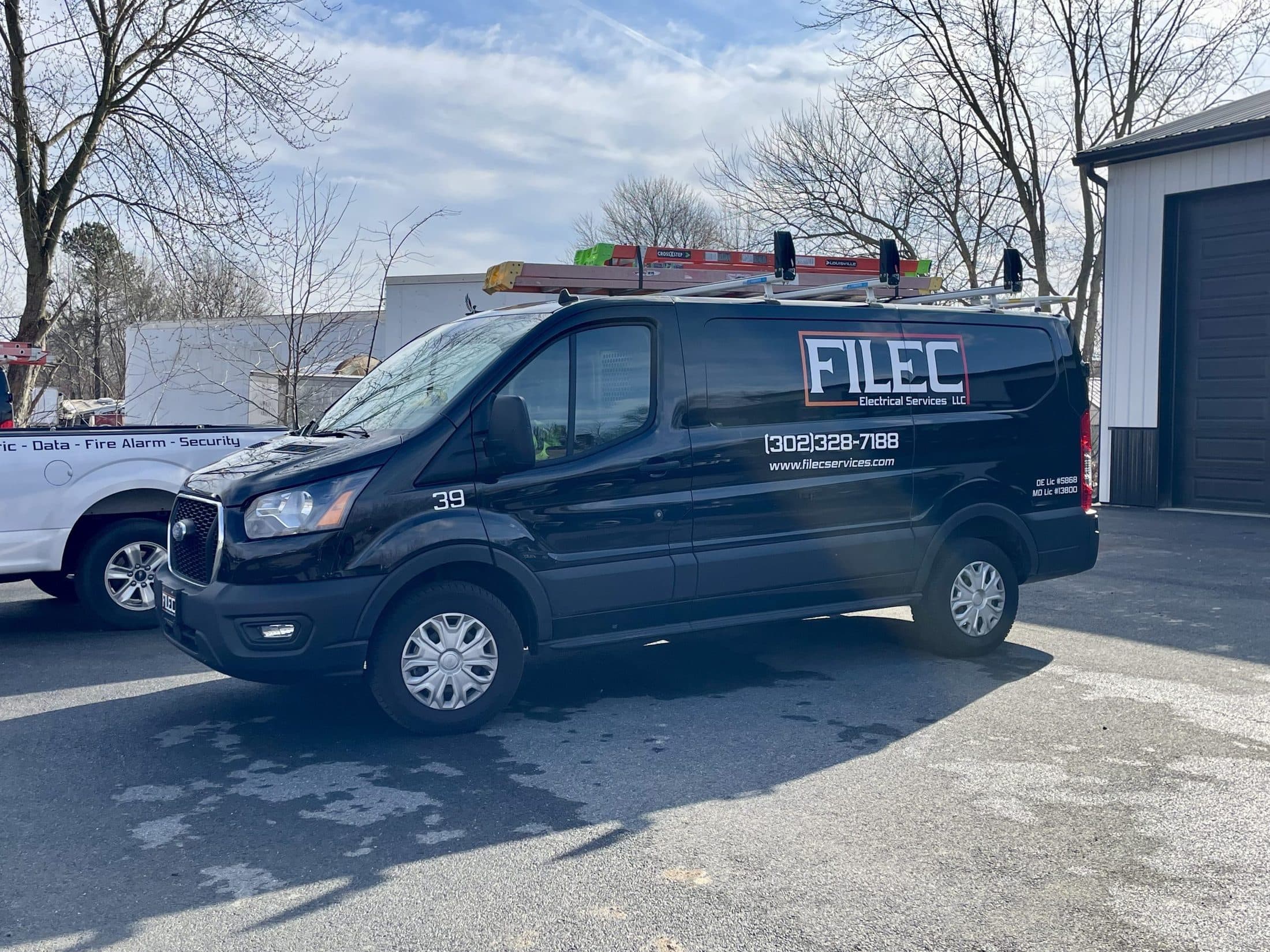 Filec service van 39, black with the company logo and phone number